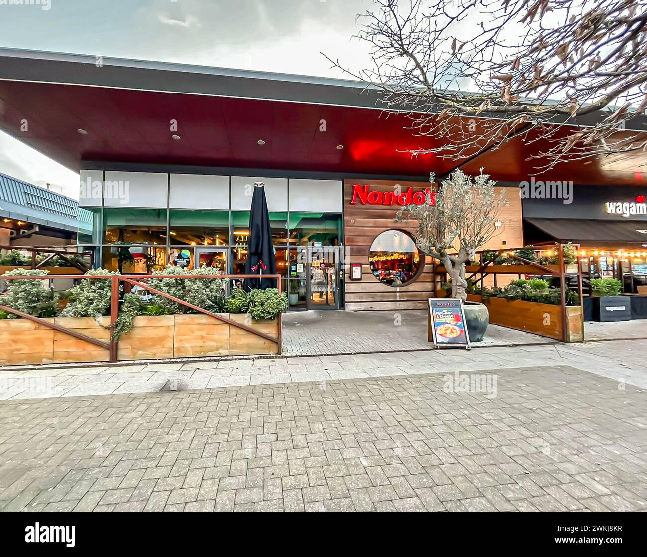 Nando's entrance. Nando's is an international casual dining restaurant chain originating from South Africa Stock Photo