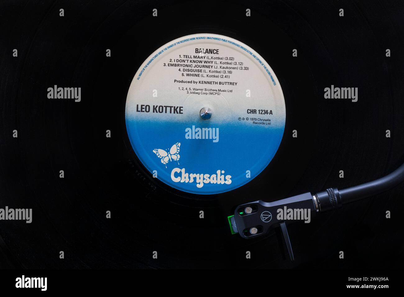 Leo Kottke Balance vinyl record album LP with tonearm, cartridge, headshell and stylus on turntable record player - 1979 Stock Photo