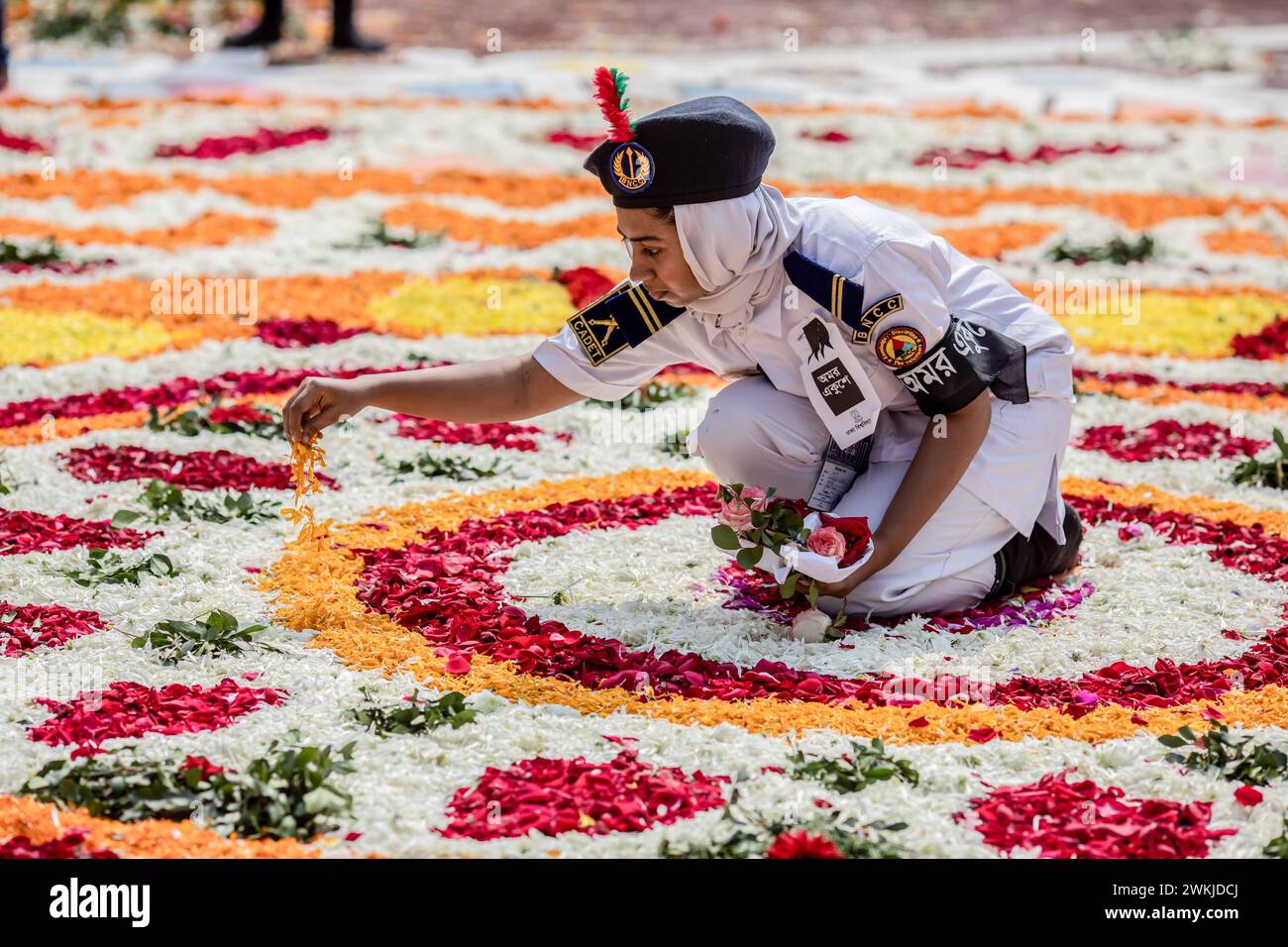 Dhaka, Bangladesh. 21st Feb, 2024. A volunteer arranges flower petals