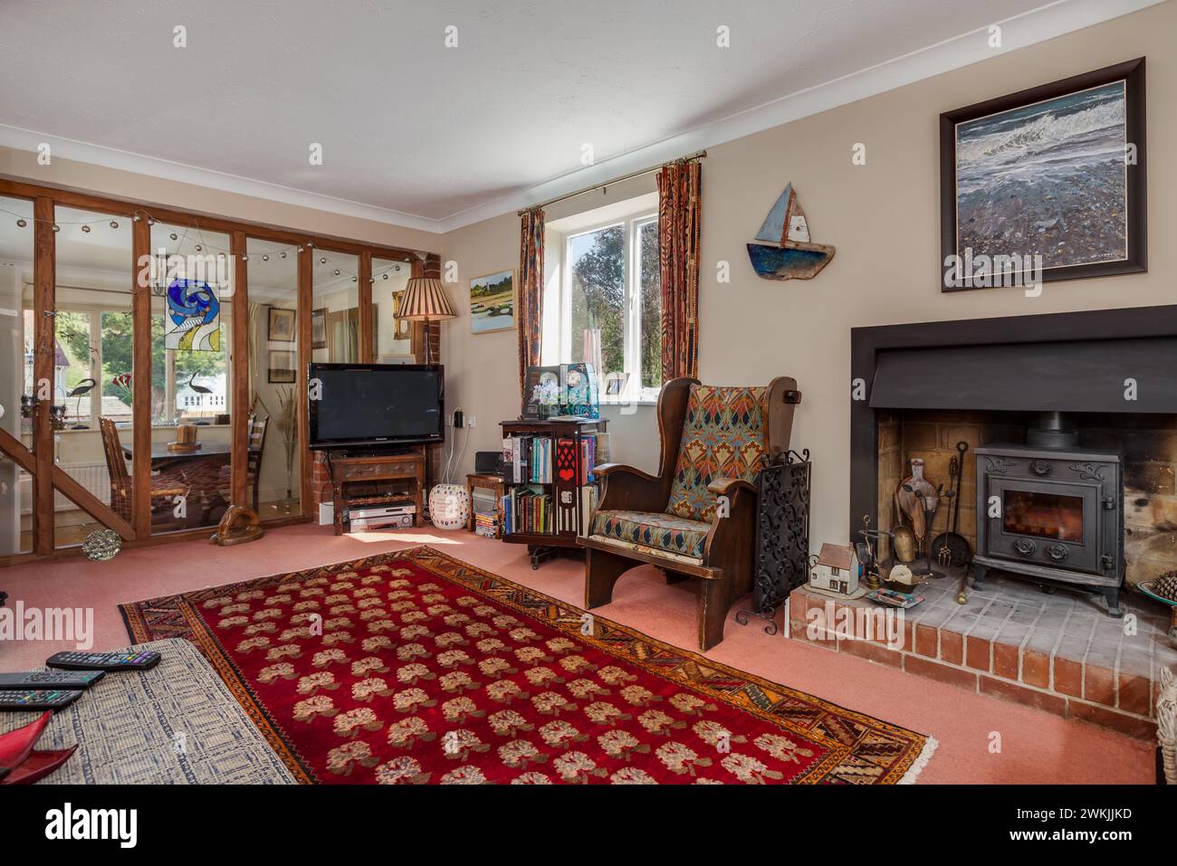 Ashley, Newmarket, Suffolk - 20 April 2015: Traditional furnished living room with fireplace and log burner Stock Photo