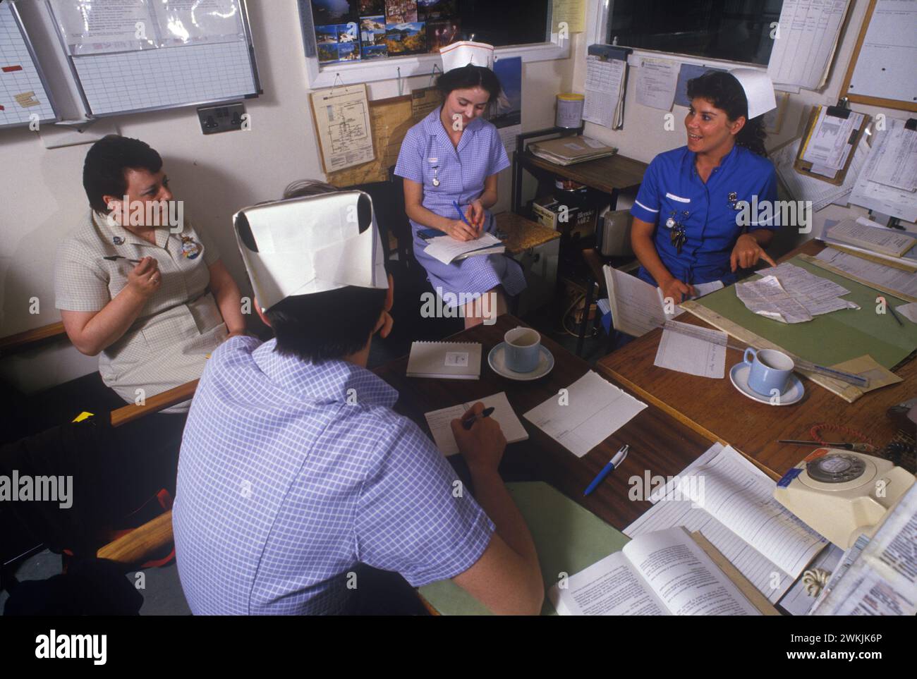 Staff nurse at the Alder Hey Children's Hospital, she is having a meeting in the 'nurses station'  going through the children's hospital records. Liverpool, England circa 1988. 1980S UK HOMER SSYKES Stock Photo