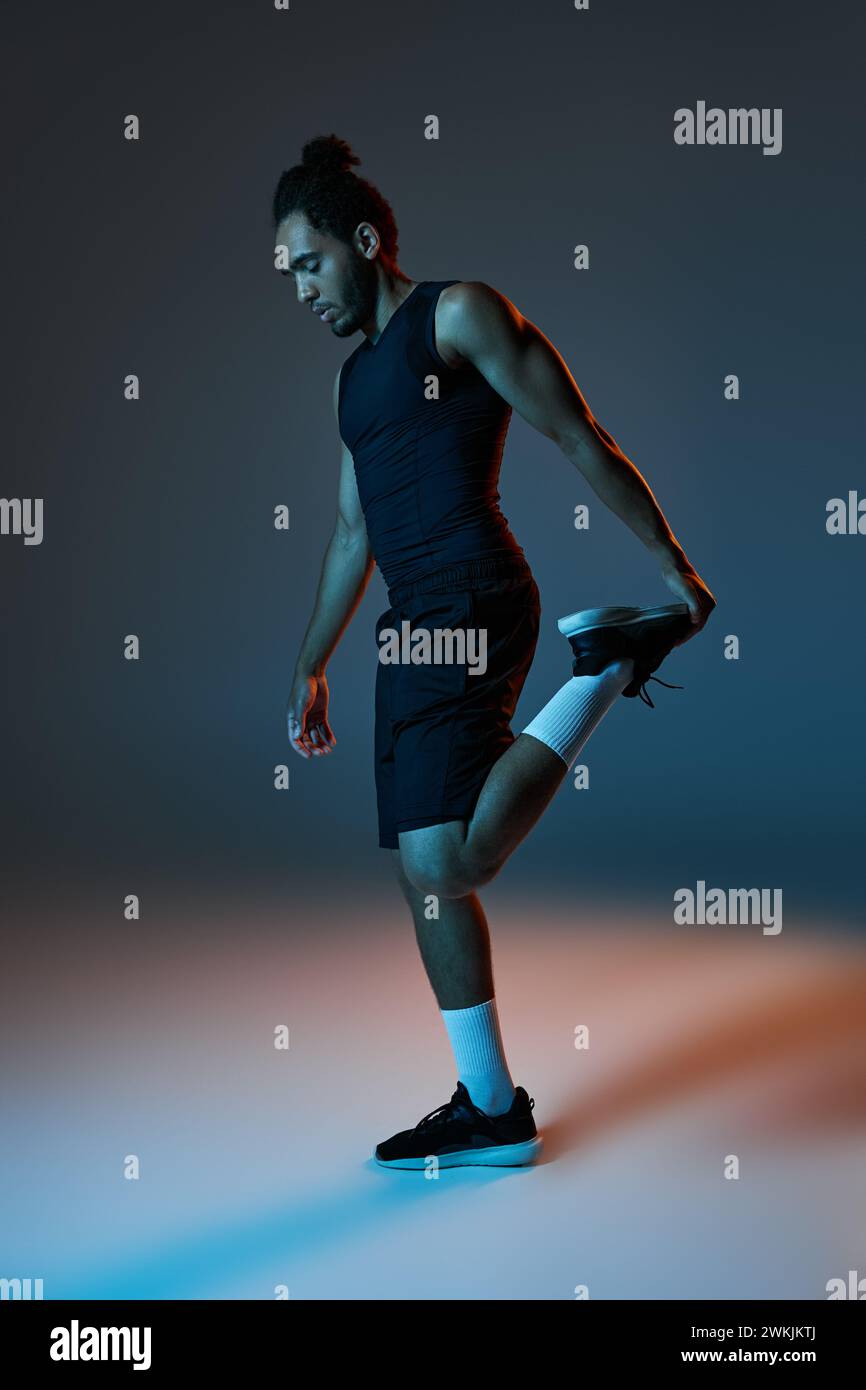 Sporty young man stretching muscles hi-res stock photography and images ...