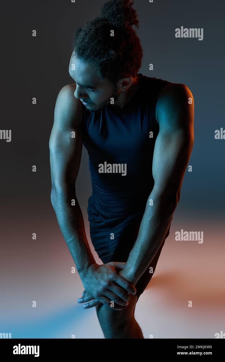 Sporty young man stretching muscles hi-res stock photography and images ...