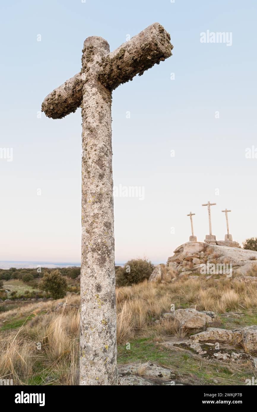 Three Crosses of carved stone on granite rock at dusk of Heaven Stock Photo