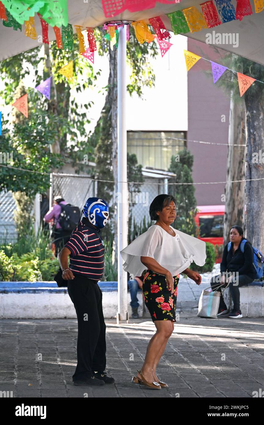 Dancer with wrestling mask and partner dancing in a public square in Colonia Centro, Mexico City Stock Photo