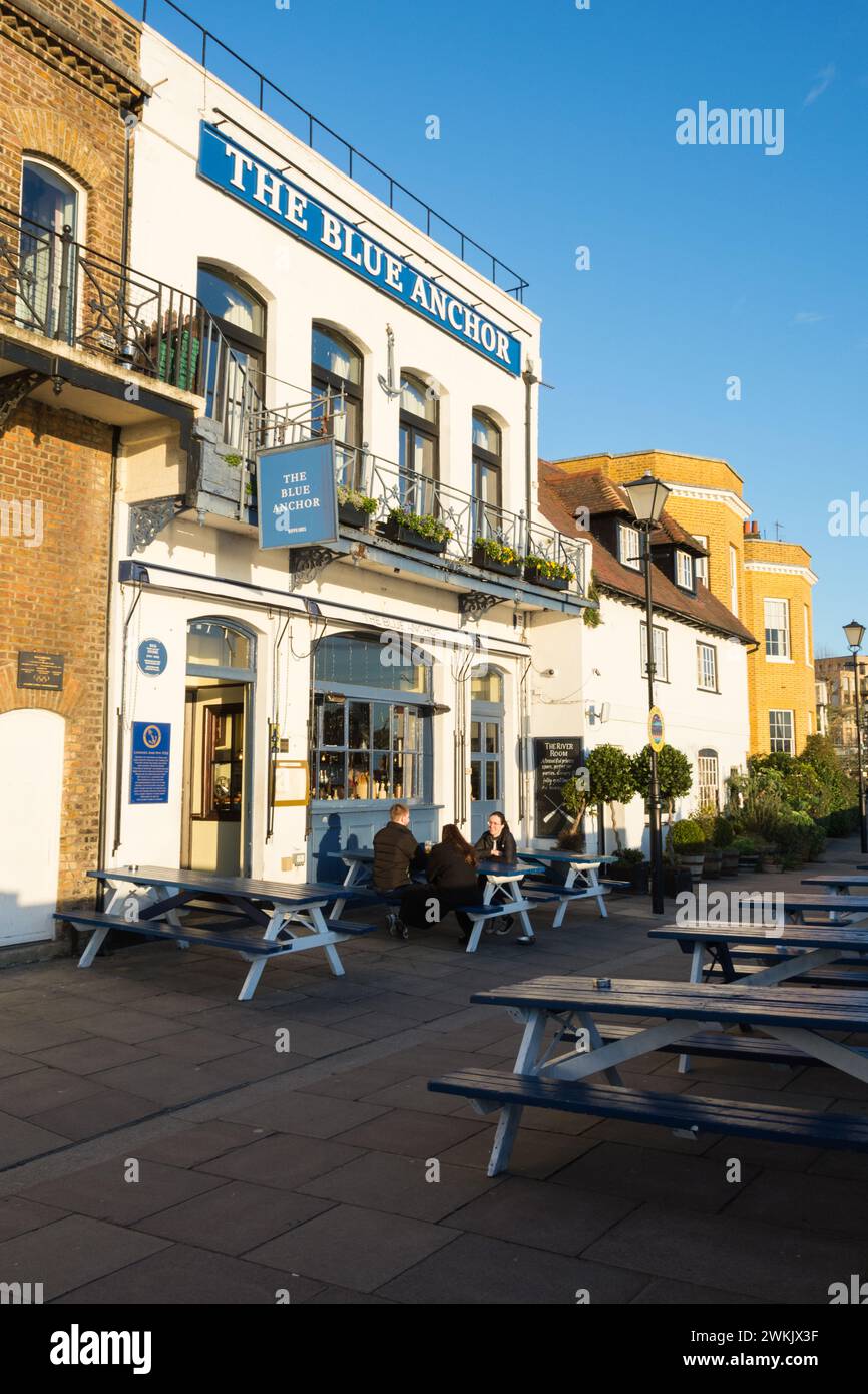 Customers sitting outside famous Blue Anchor public house on the banks of the River Thames in Hammersmith, southwest London, England, UK Stock Photo