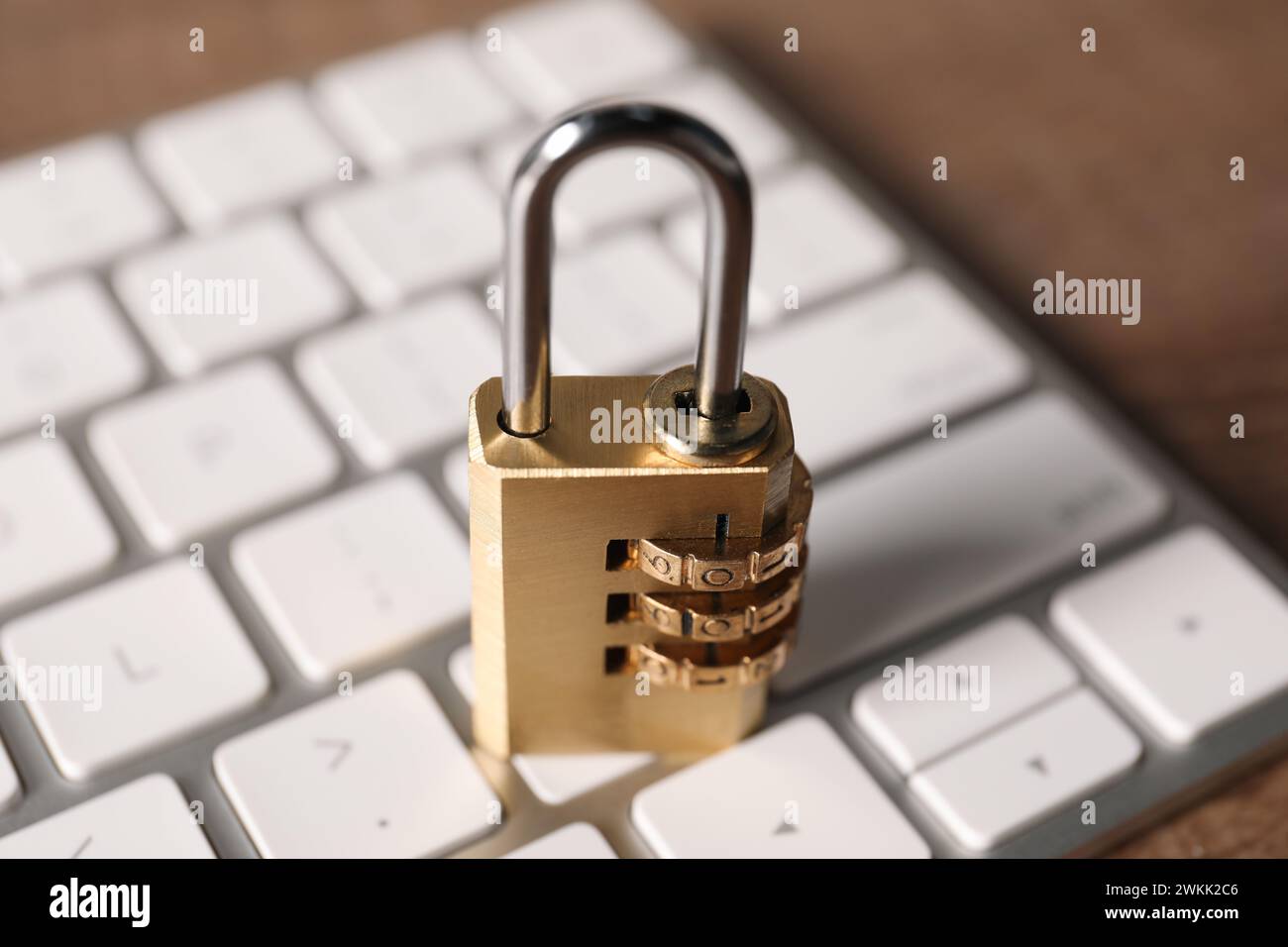 Cyber security. Keyboard with padlock on table, closeup Stock Photo