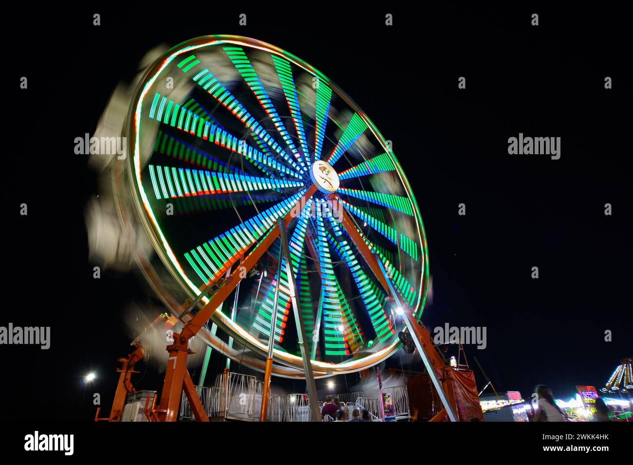 Neon Ferris Wheel Motion Blur at Night, Fairground Ambience Stock Photo ...