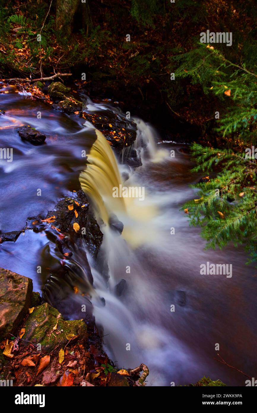 Autumnal Waterfall in Forest with Silky Water Flow Stock Photo