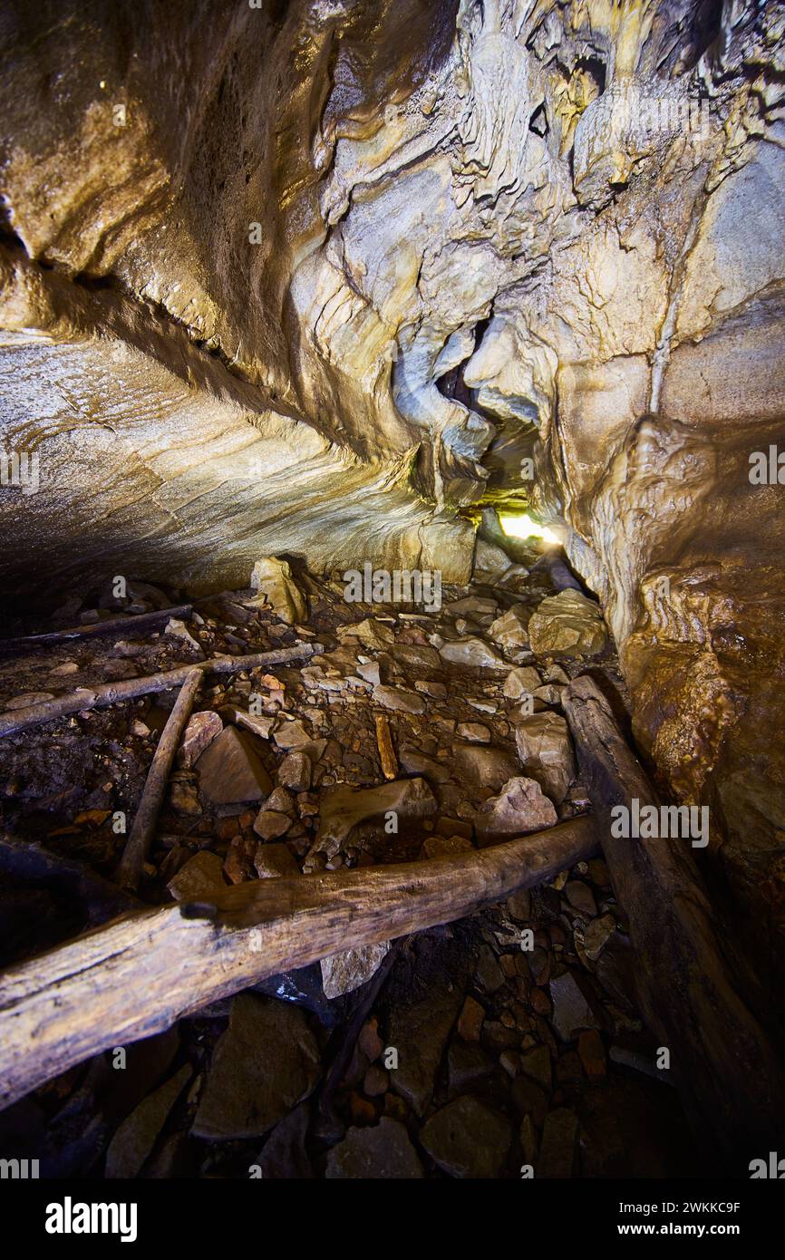 Rugged Cave Interior with Logs and Earthy Tones, Low Angle View Stock Photo