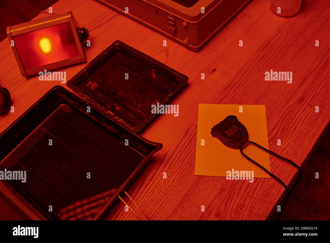 Art of analog photography captured in darkroom with red light, with