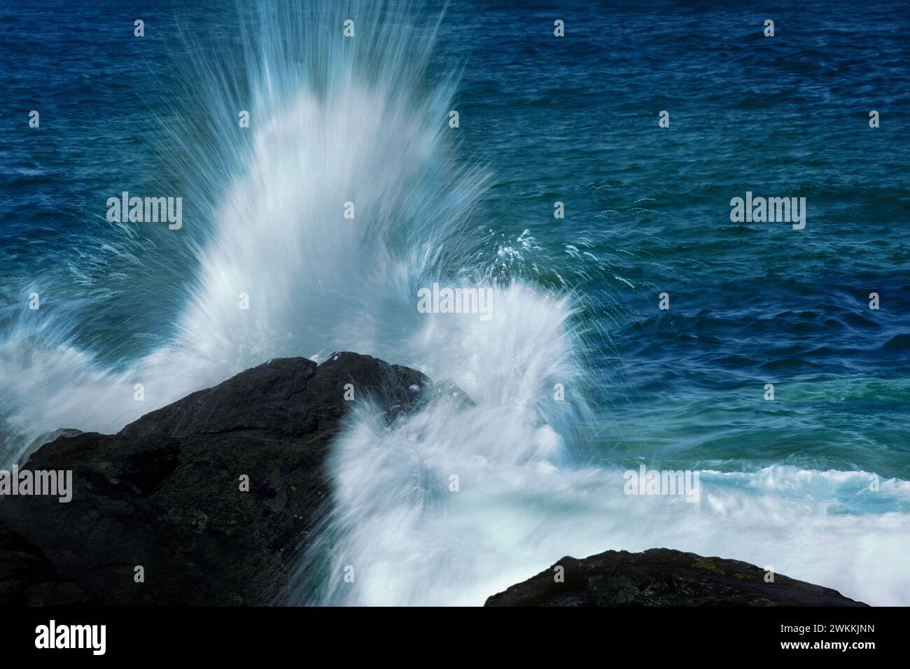 Wave crashing on rocks Stock Photo