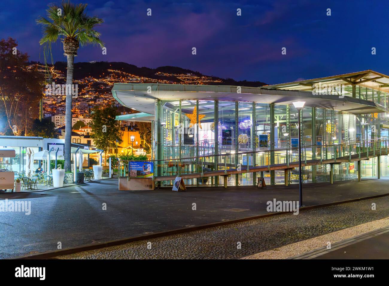 Night view of the illuminated lower Cable Car gondola station with the lights of Monte visible in the distance, Funchal, Portugal, Madeira Island. Stock Photo