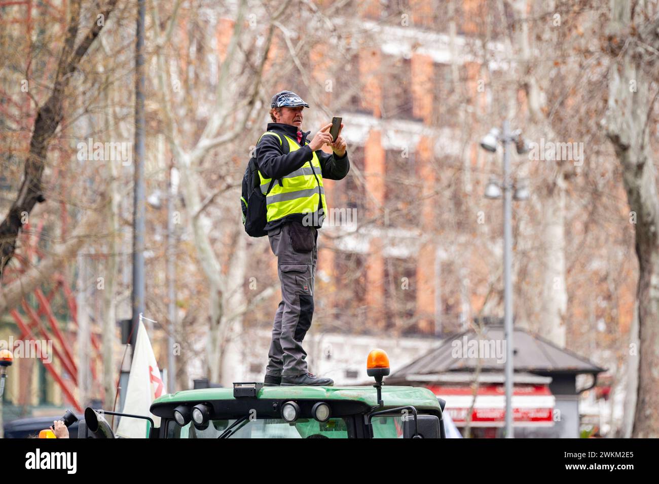 Spanish farmer demonstration in Madrid A protester seen on the top of a tractor during the farmers demonstration in Madrid the protest, organized by Spanish trade unions, is focused on concerns over unfair competition from products originating outside the EU. Farmers are also unhappy about the meager profits derived from their crops and are critical of EU agricultural policy. Madrid Puerta de Alcala Madrid Spain Copyright: xAlbertoxGardinx AGardin 20240221 manifestacion tractores madrid 136 Stock Photo