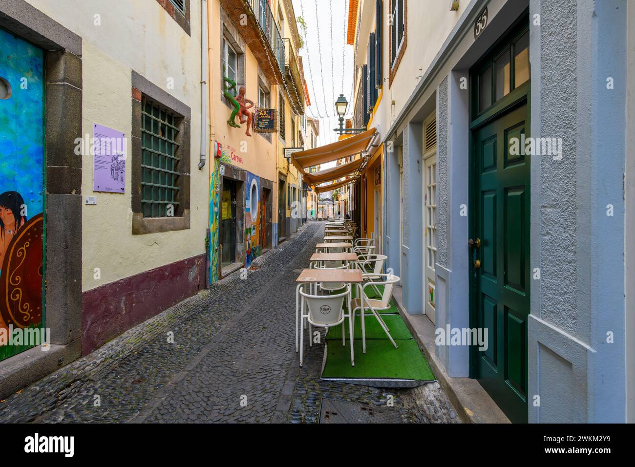 The famous Rua de Santa Maria narrow street of cafes, colorful doors and shops in the historic medieval old town of Funchal, Madeira Portugal. Stock Photo