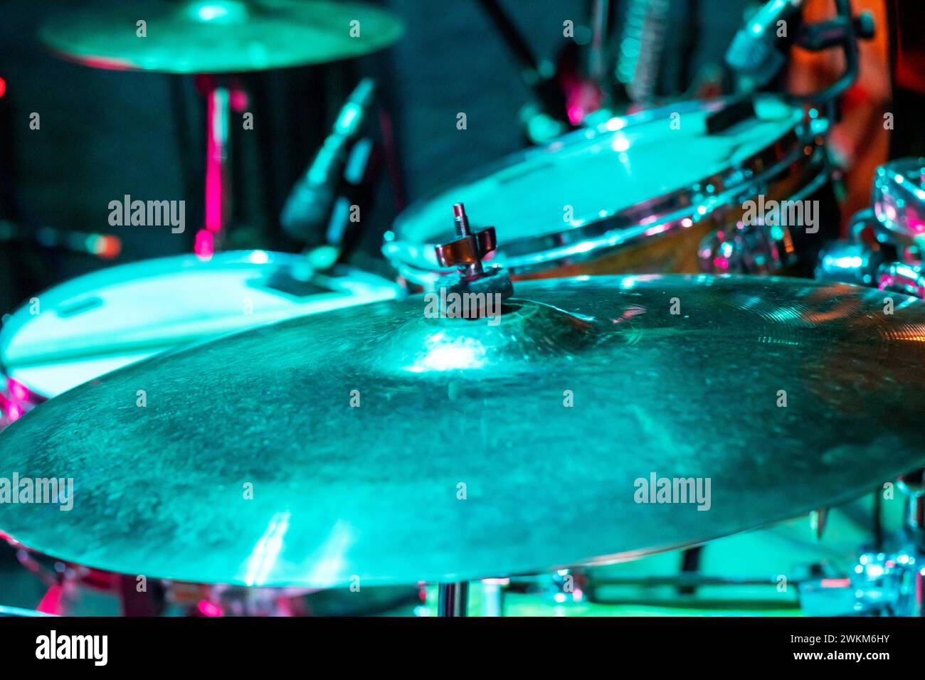 Drum kit in green light close up top wiew Stock Photo