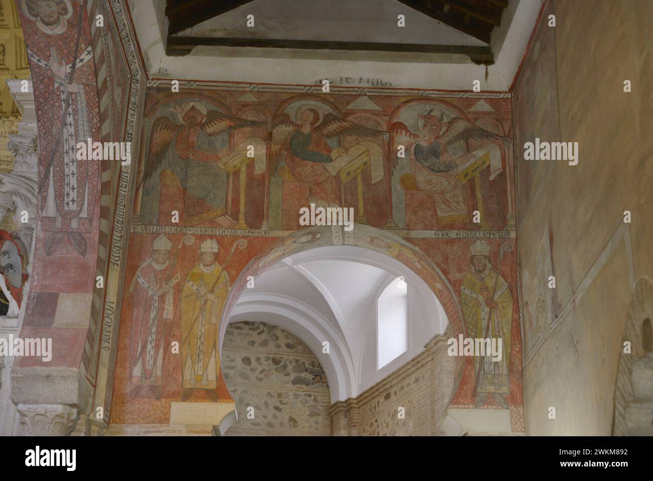 Spain, Toledo. Church of San Román. Built in Mudejar style in the 13th century. Paintings on the eastern front of the Nave of the Epistle. In the upper part: Saint Matthew, Saint Mark and Saint Luke, three of the evangelists. They are depicted winged and with their faces changed by their zoomorphic symbol, as they write the Gospels. In the lower part, three Confessors of the Catholic Church: Saint Eugene, Saint Isidore and Saint Gregory. Stock Photo