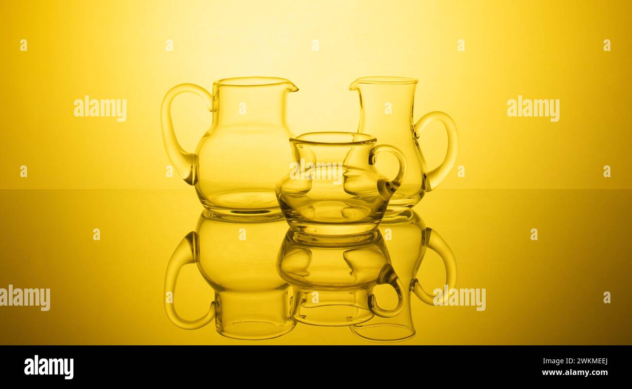 A stunning composition of elegant glassware arranged against a captivating glowing gradient background. The interplay of light and shadow creates a so Stock Photo