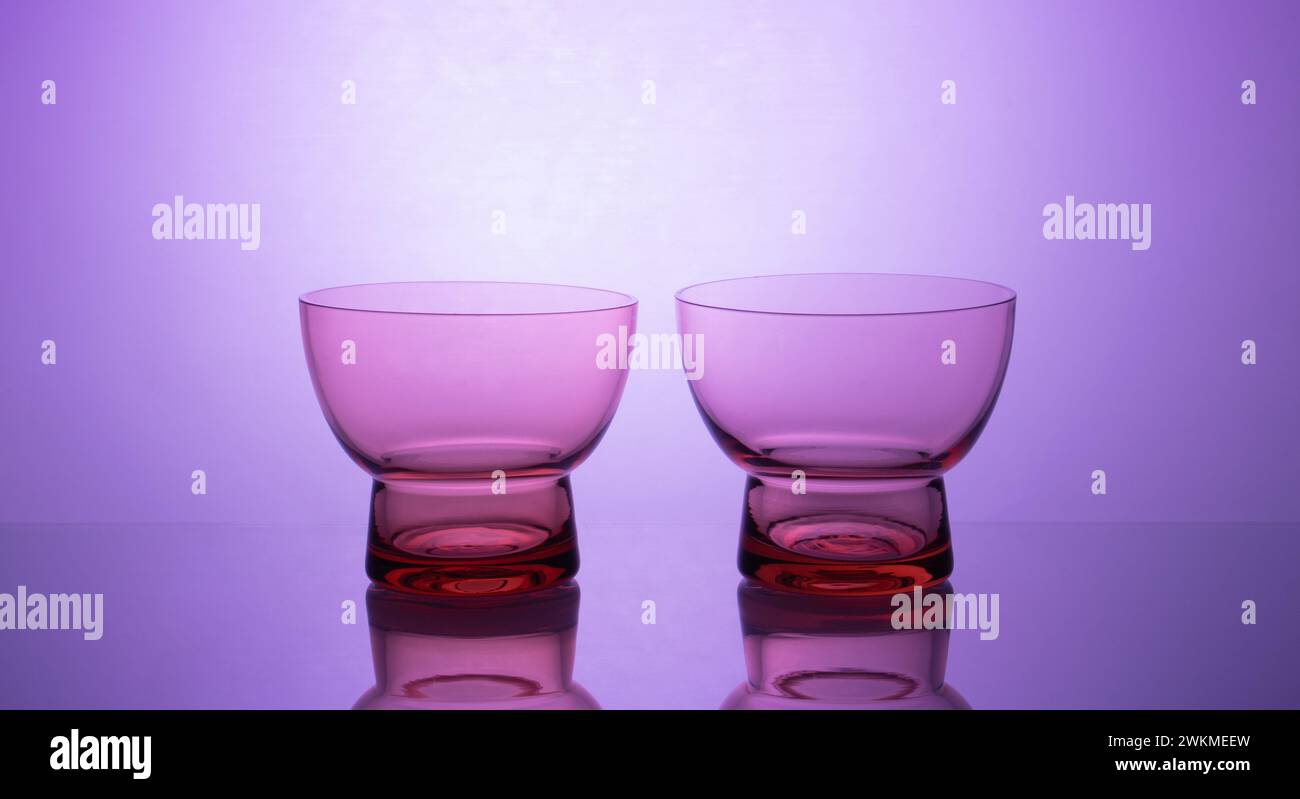 Elegant glassware displayed on a mesmerizing glowing gradient background, creating a sophisticated ambiance with vibrant colors and luxury reflections Stock Photo