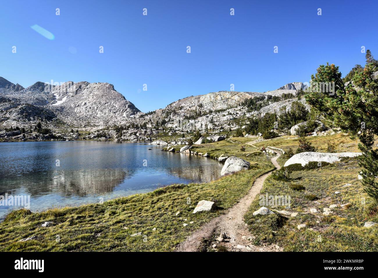 Trail beside mountain lake Stock Photo