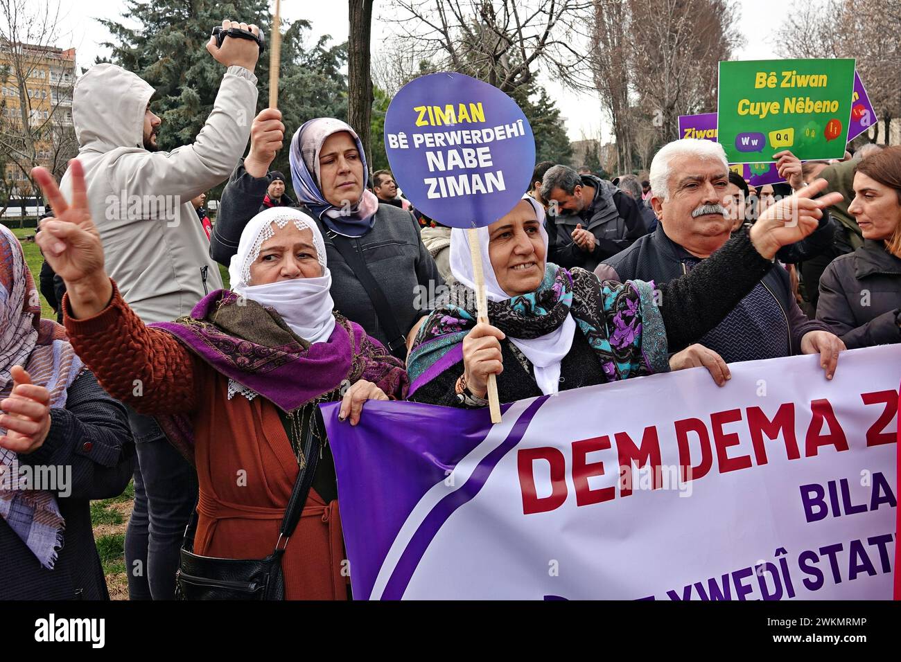 Participants hold a banner and placard during the International Mother Language Day demonstration. The International Mother Language Day is celebrated with a march in Diyarbakir, Turkey. The demonstration, is attended by the Peoples' Equality and Democracy Party (DEM Party), Democratic Regions Party (DBP) and some Kurdish organisations, demanding that the Kurdish language be accepted as an official language and that education be provided with it. Demonstrations are organised in all Kurdish-populated cities in Turkey to protest against the oppression of the Kurdish language. In Turkey, Kurdish Stock Photo