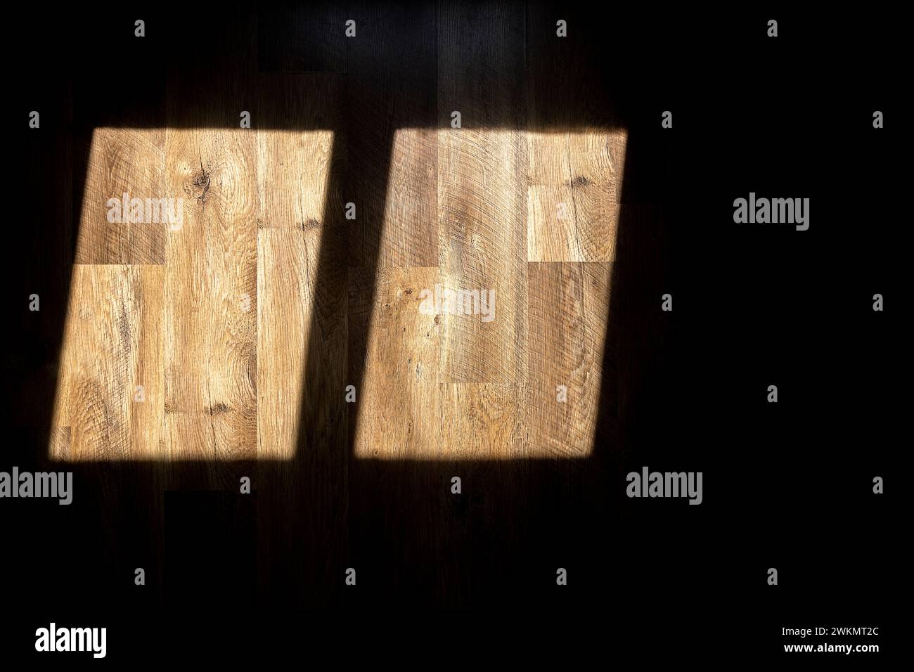 A shadow from the window. Sunlight from the window falls on the wooden floor. Stock Photo