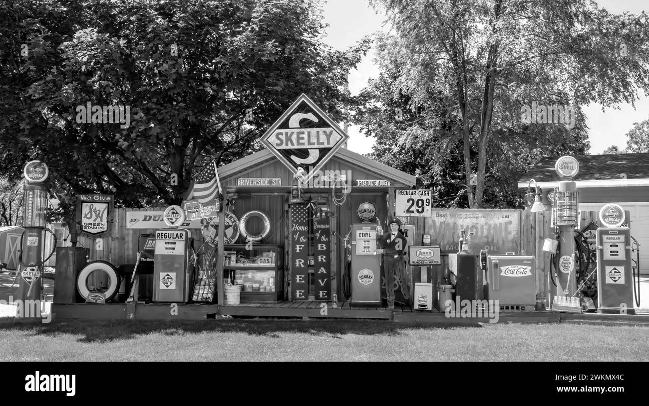 Black and white vintage Skelly memorabilia and other antique automotive objects on display in a yard on a summer day in St. Cloud, Minnesota USA. Stock Photo