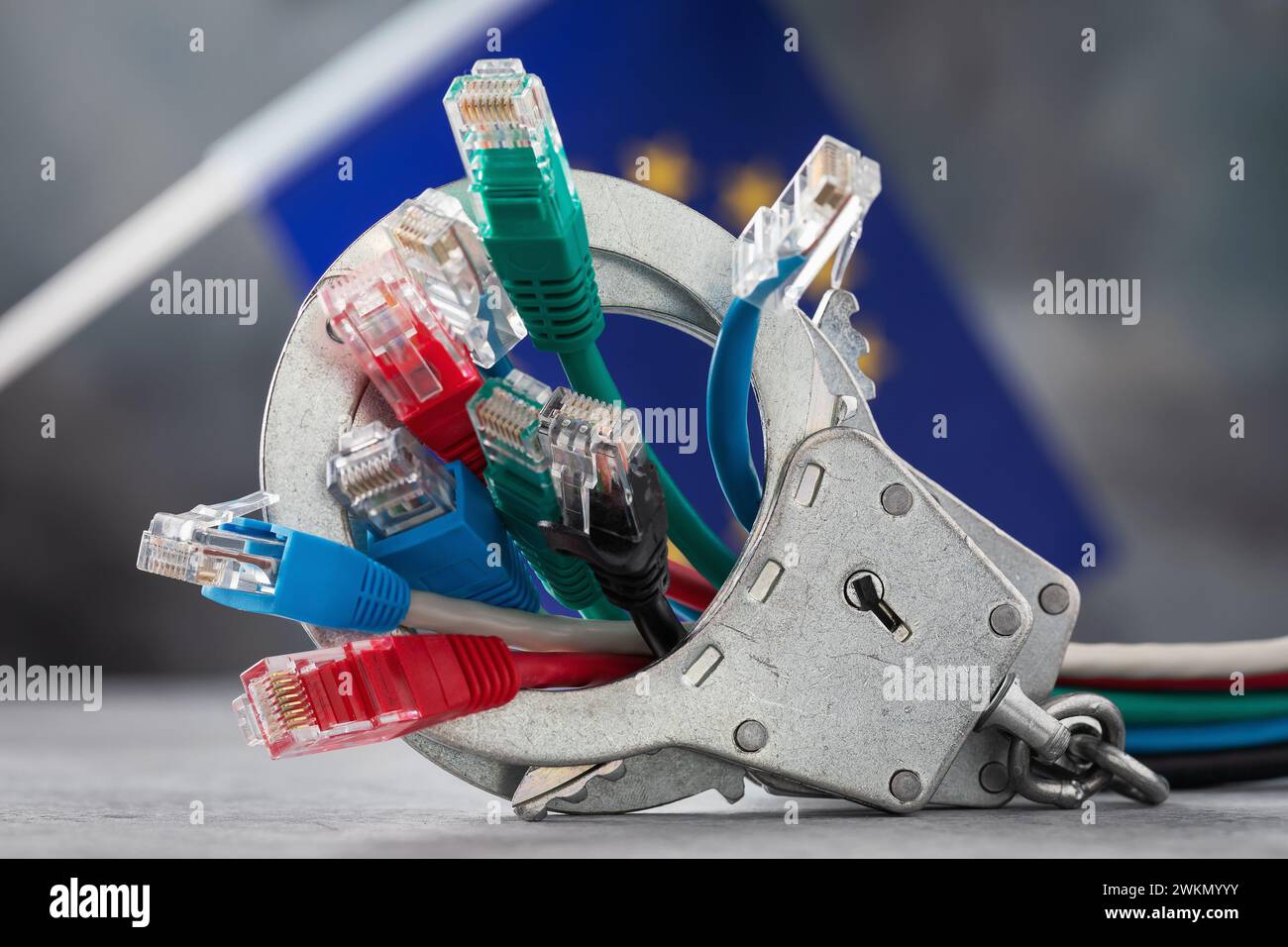 Closed handcuffs on network wires and the EU flag on an abstract background, a concept on the topic of punishment for crimes on the network Stock Photo