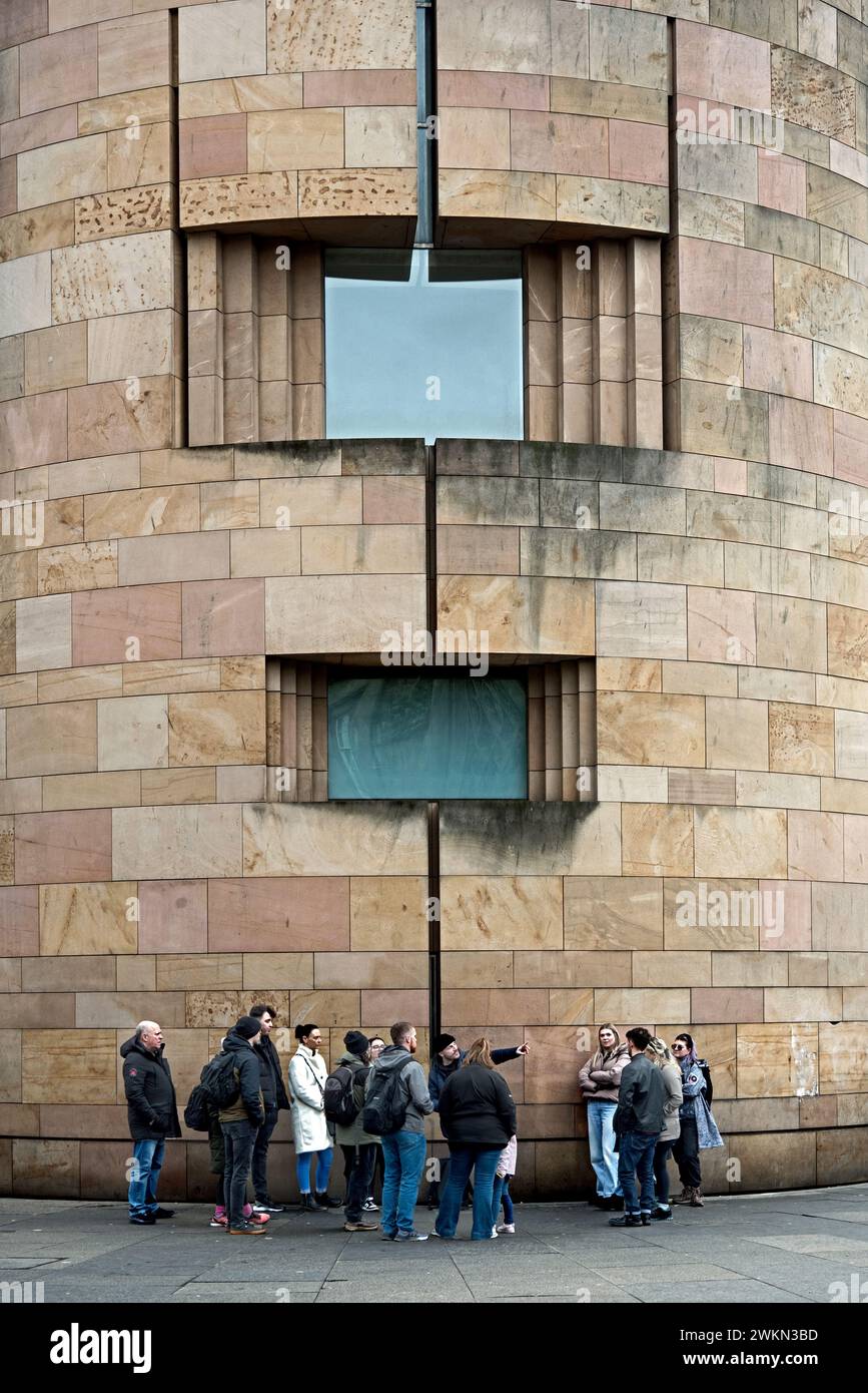 Tourists on a walking tour outside the National Museum of Scotland on Chambers Street, Edinburgh, Scotland, UK. Stock Photo