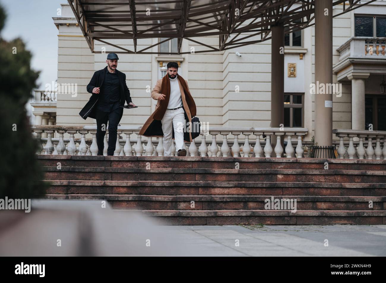 Two men walking down staircase hi-res stock photography and images - Alamy