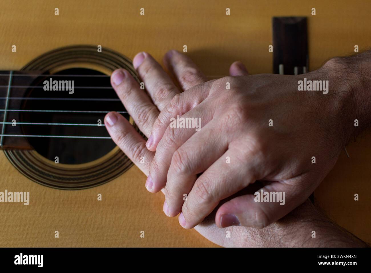 Hands on top of a classical guitar. Quality music Stock Photo