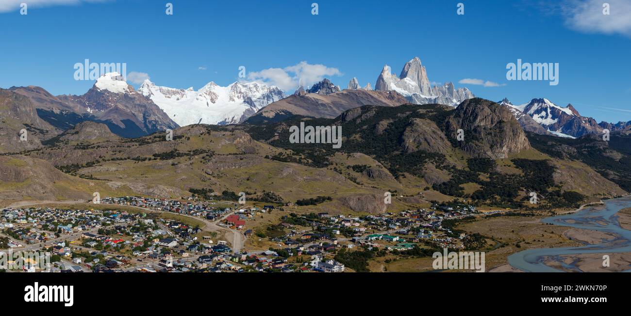 El Chalten village with panorama of mountain range Fitz Roy on a sunny day with blue sky. It is a mountain in Patagonia, on the border between Stock Photo