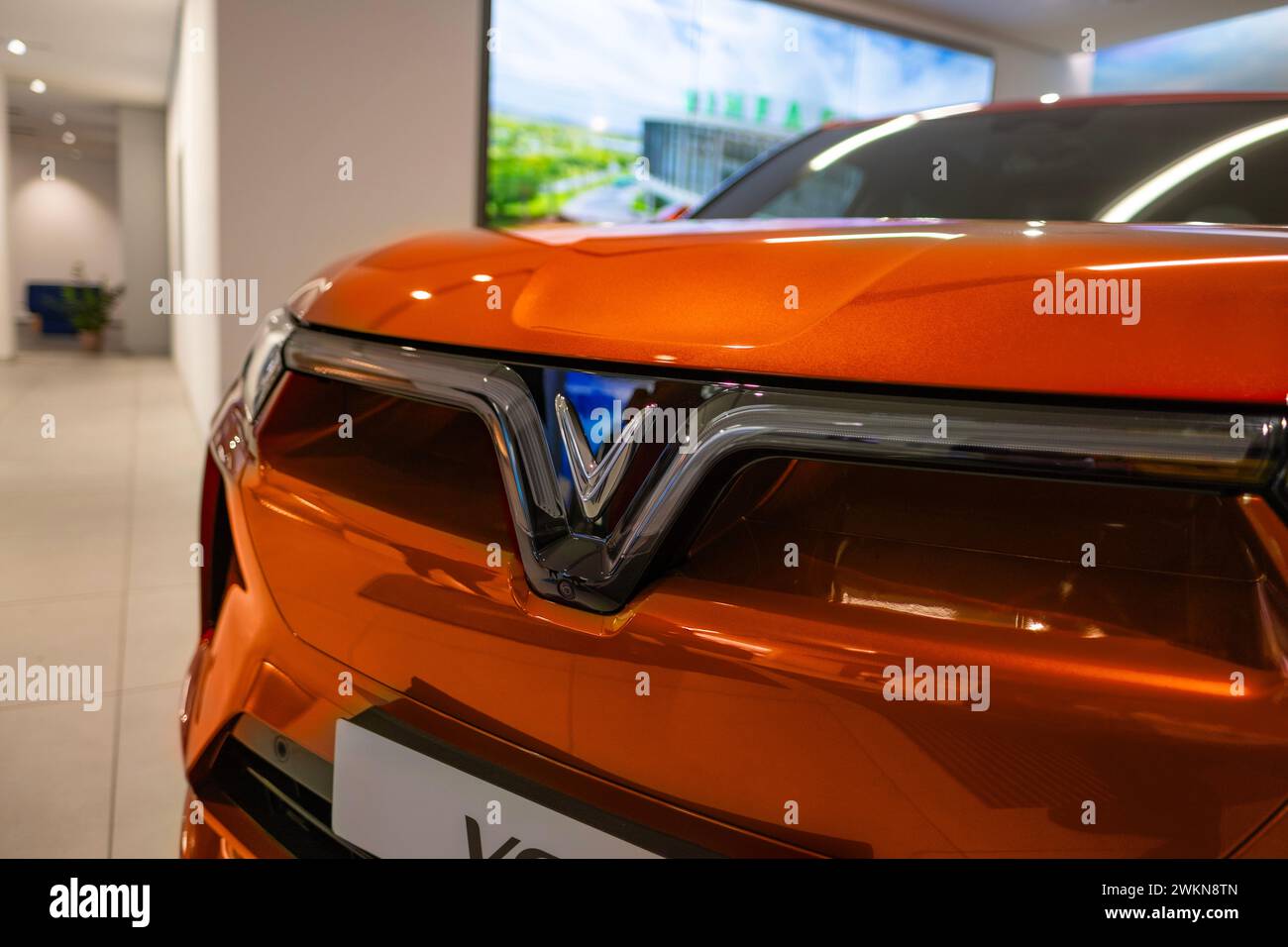 orange Vinfast vf 9 electric SUV in Studio, advanced technologies