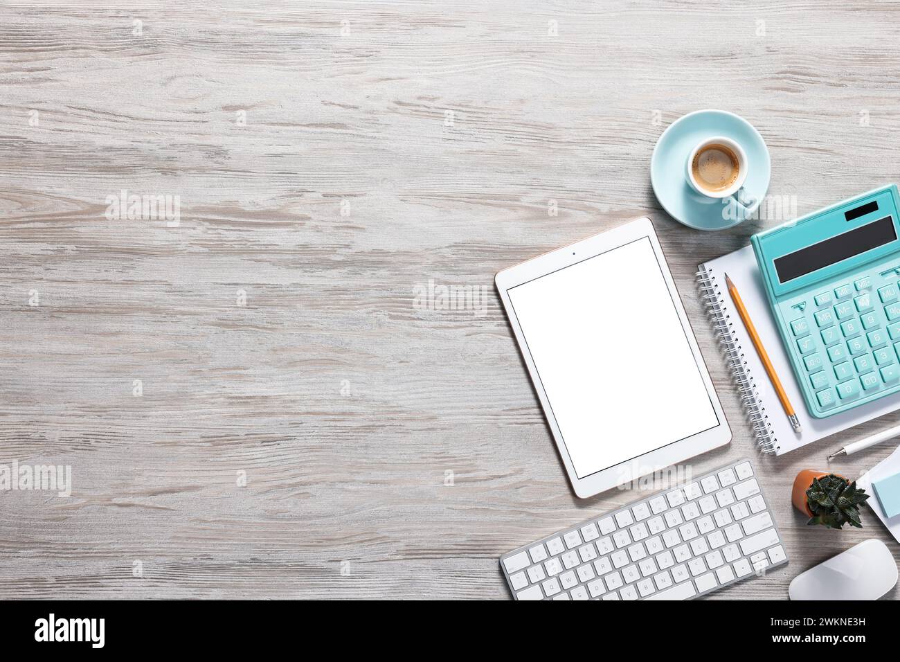 Flat lay composition with modern tablet on white wooden table. Space for text Stock Photo