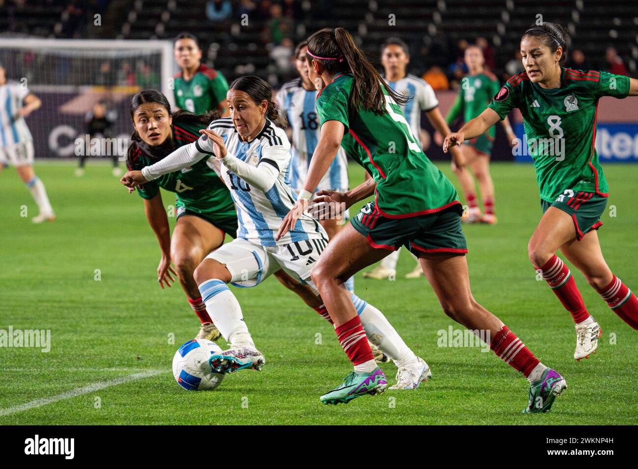 Argentina midfielder Dalila Ippólito (10) is defended by Mexico defender Karen Luna (5) and defender Rebeca Bernal (4) during the Concacaf W Gold Cup Stock Photo