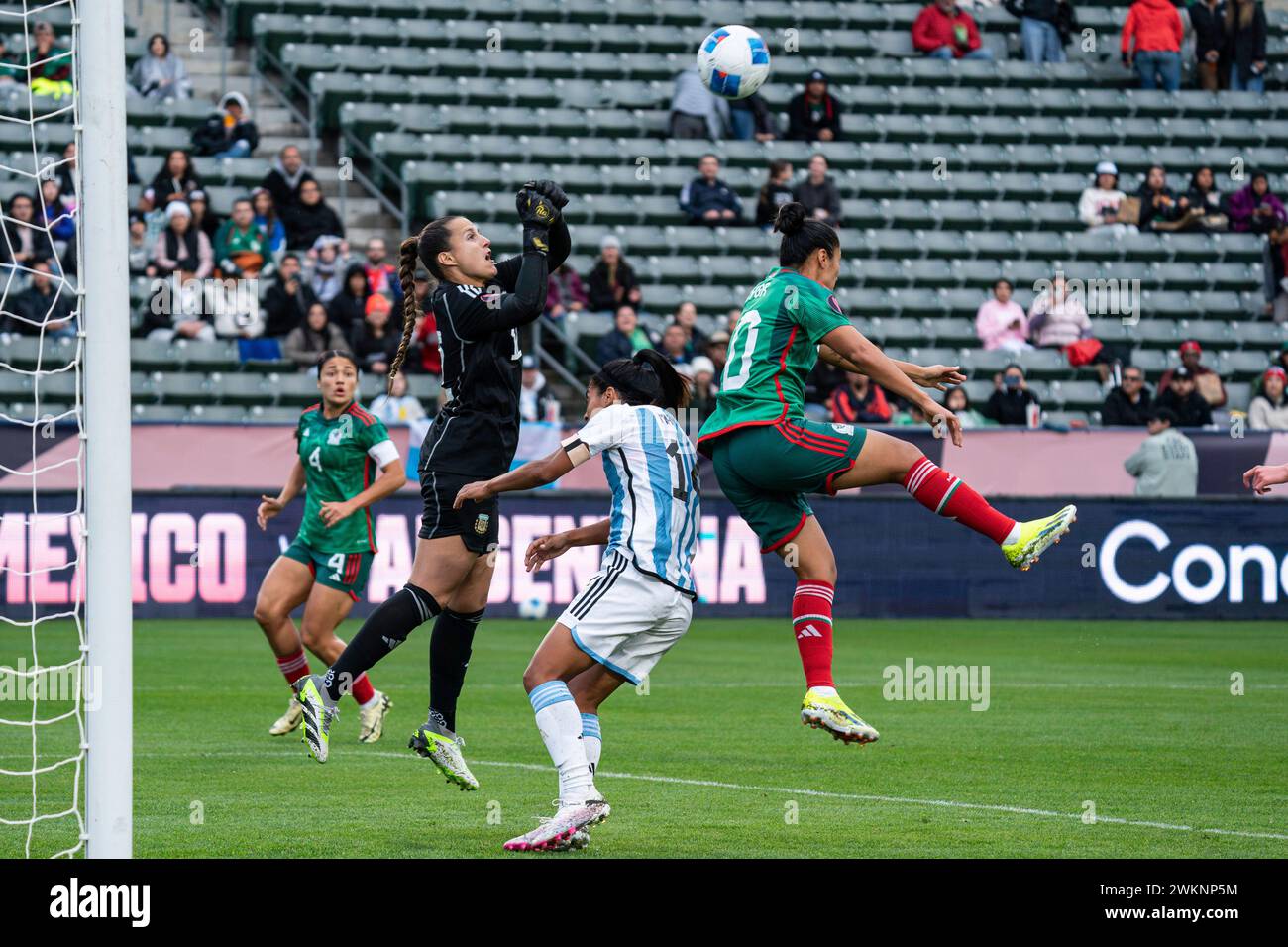 Argentina goalkeeper Laurina Oliveros (12) punches away a free kick intended for Mexico midfielder Stephany Mayor (10) during the Concacaf W Gold Cup Stock Photo