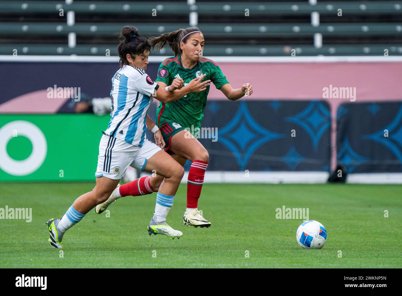 Argentina midfielder Vanina Preininger (5) challenges Mexico forward María Sánchez (7) for possession during the Concacaf W Gold Cup Group A match, Tu Stock Photo