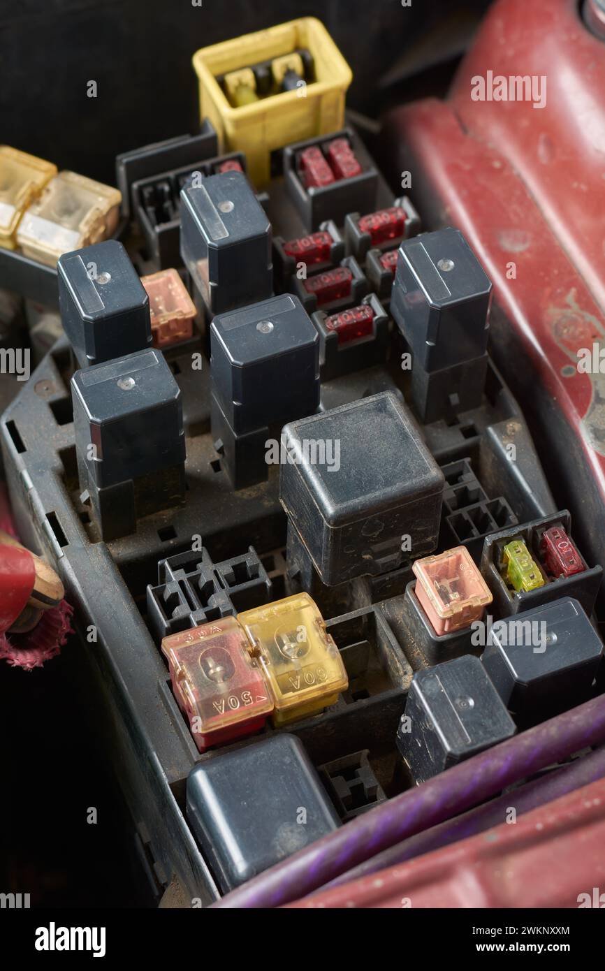 fuse box, panel or block in a car, located in engine compartment, protect vehicle electrical components from damage cause by faults, selective focus Stock Photo