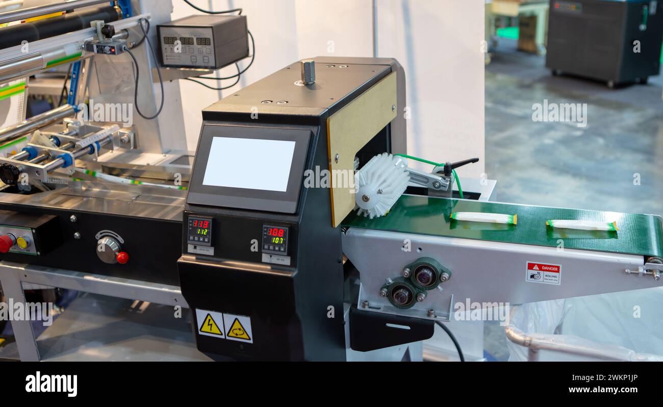 Automatic food flow wrapping machine. Food packaging machine Stock Photo