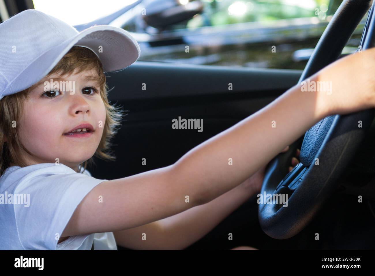 Little Driver. Cute little boy pretending to drive. Kid in car with his ...