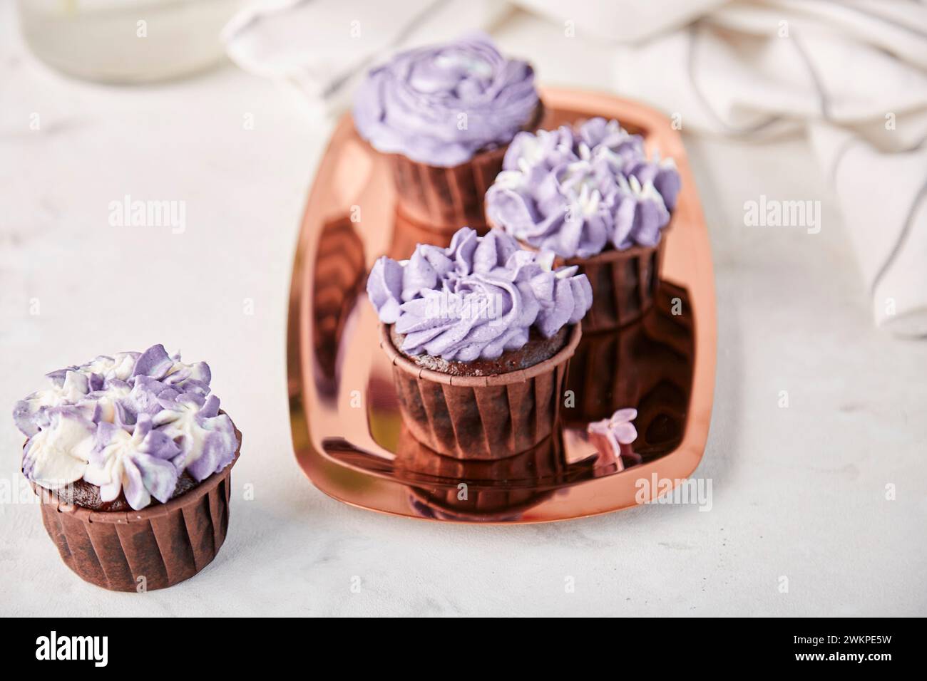 Lilac floral cupcakes, aesthetics desserts close up. Stock Photo