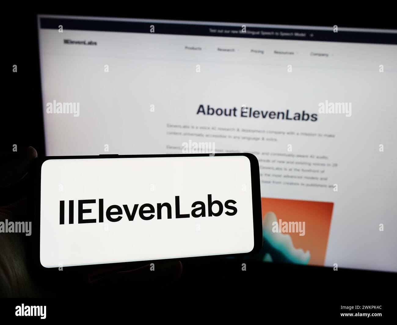 Person holding smartphone with logo of US artificial intelligence company ElevenLabs Inc. in front of website. Focus on phone display. Stock Photo