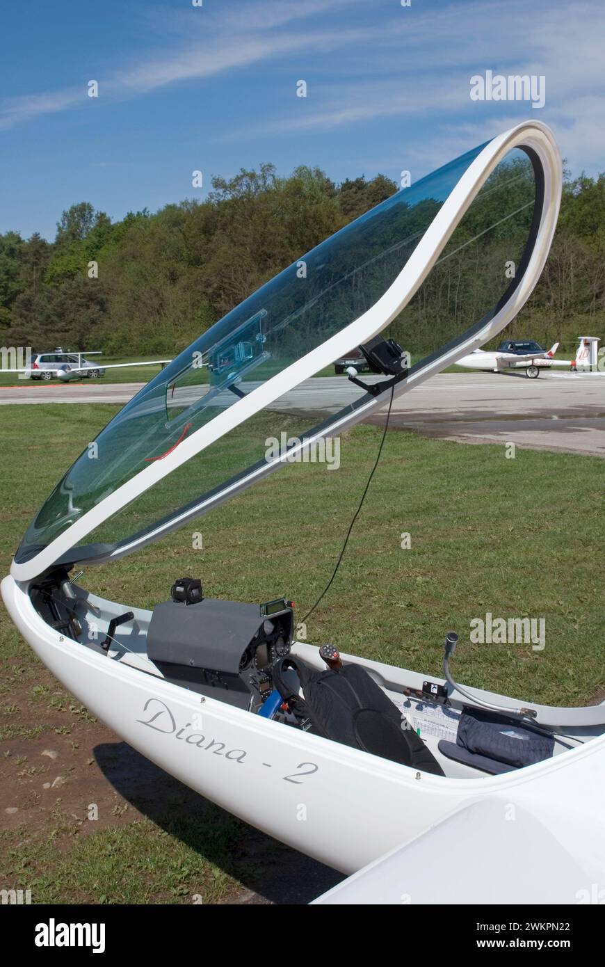 open cockpit of a glider parked on grass airfield Stock Photo