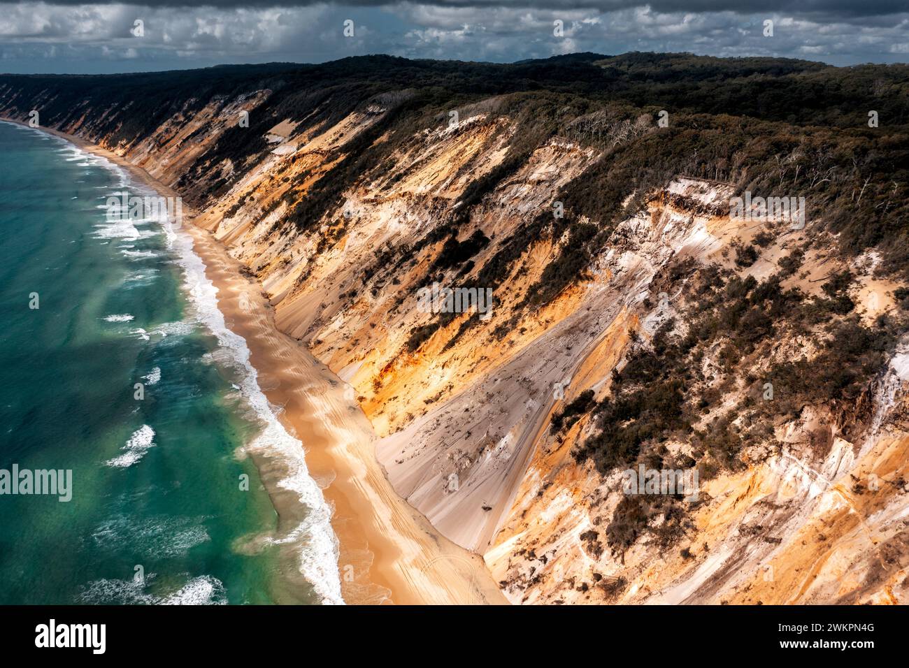 Aerial view on the coloured sand of Rainbow Beach at Queensland's Sunshine Coast. Stock Photo
