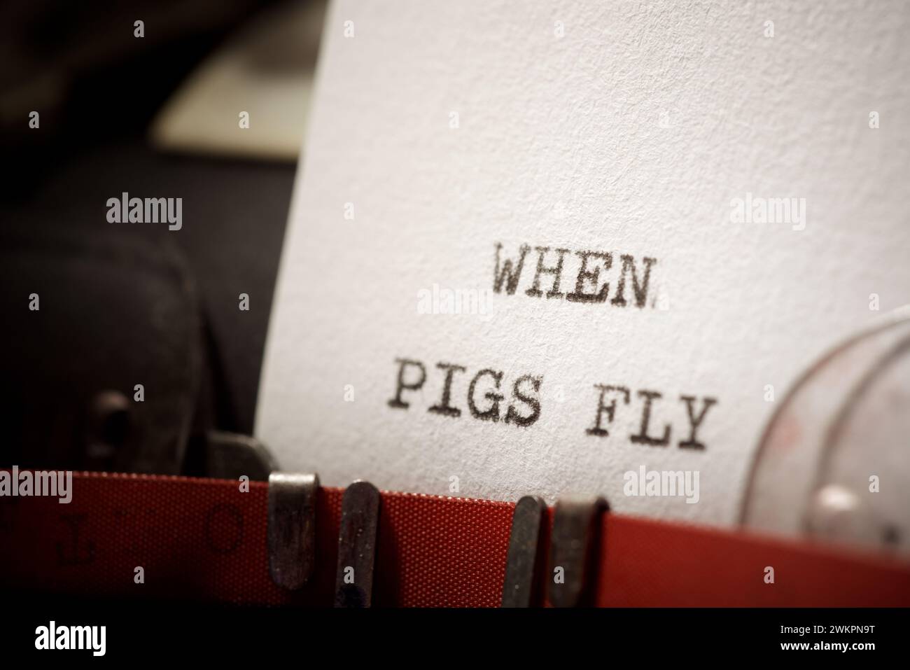 When pigs fly text written with a typewriter. Stock Photo