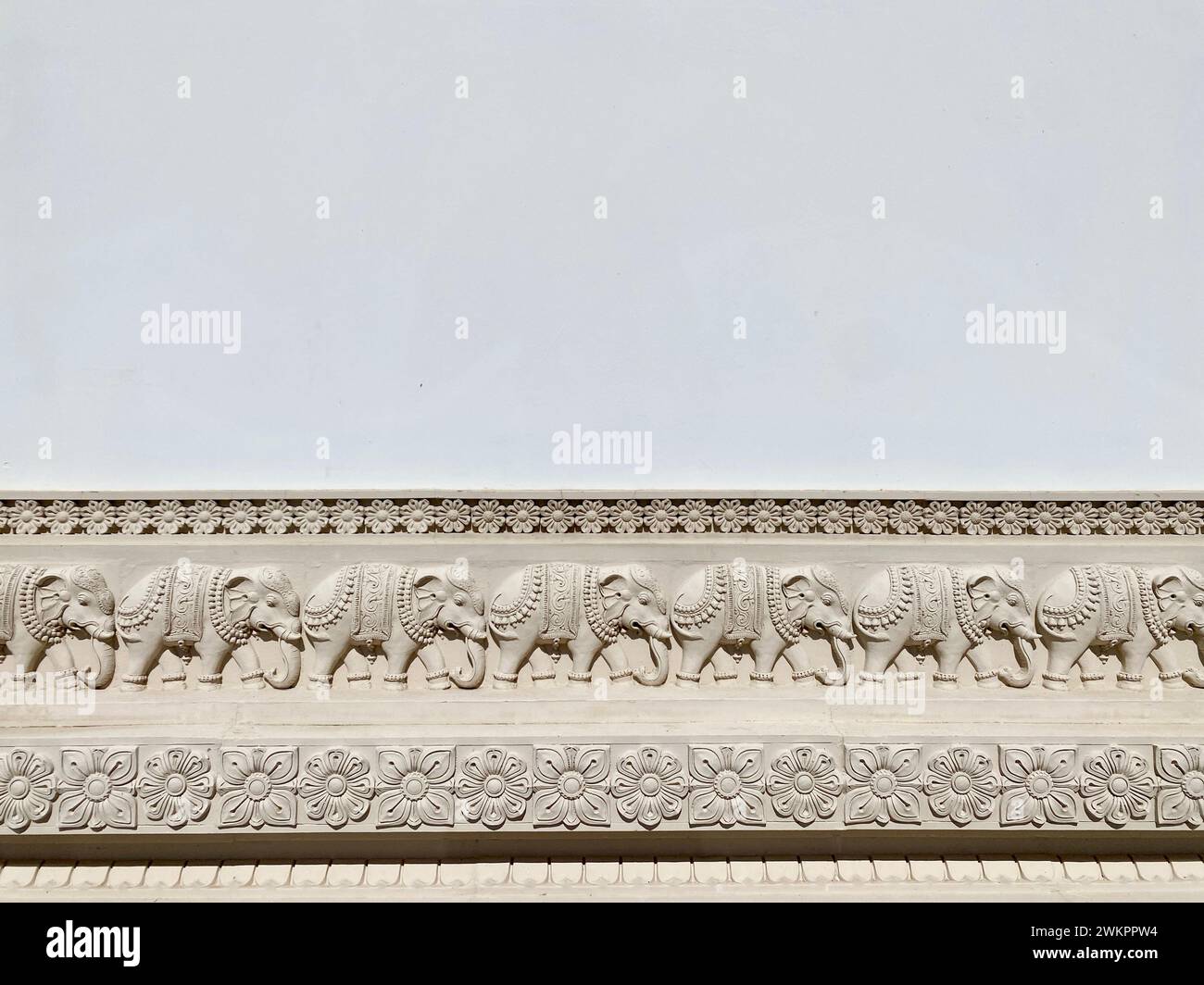 A white building adorned with carved elephants Stock Photo