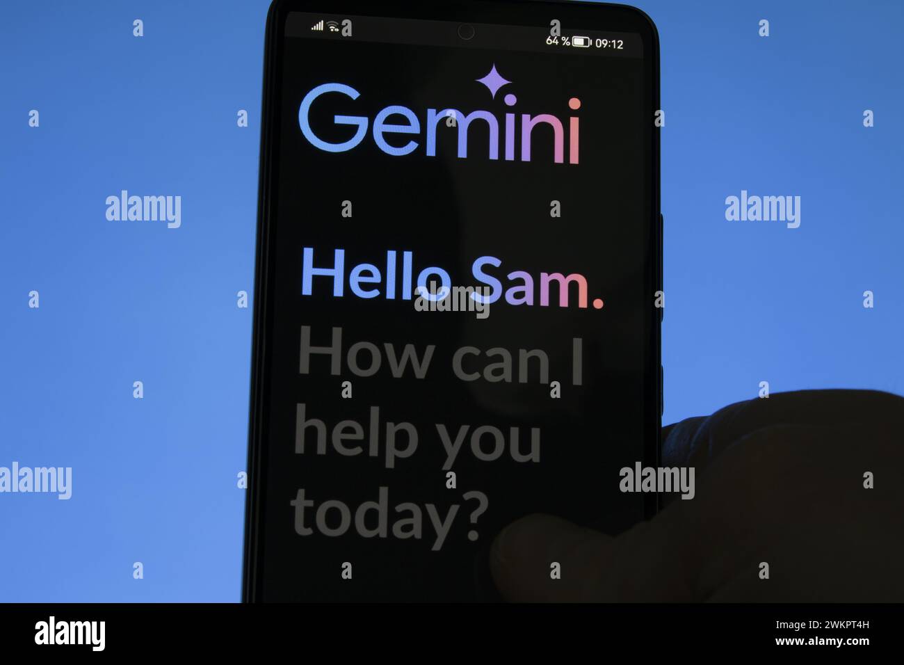 Gemini on his phone. Goggle Bard Gemini web app on a screen. Stock Photo