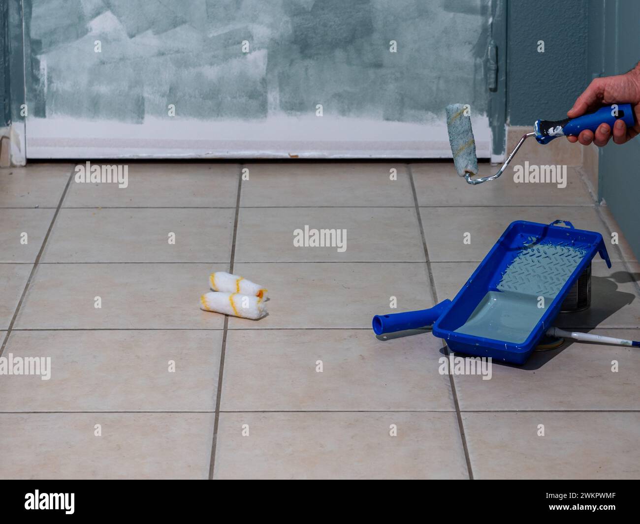 painting tools, brush, rollers, paint in a container, preparatory work