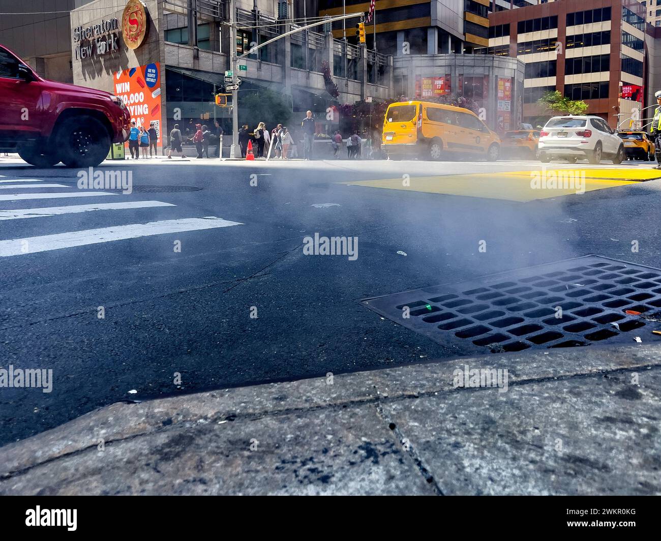 New York, USA; June 4, 2023: Smoke coming from the underworld of the Big Apple, coming out into the streets through the vents in the ground of Manhatt Stock Photo