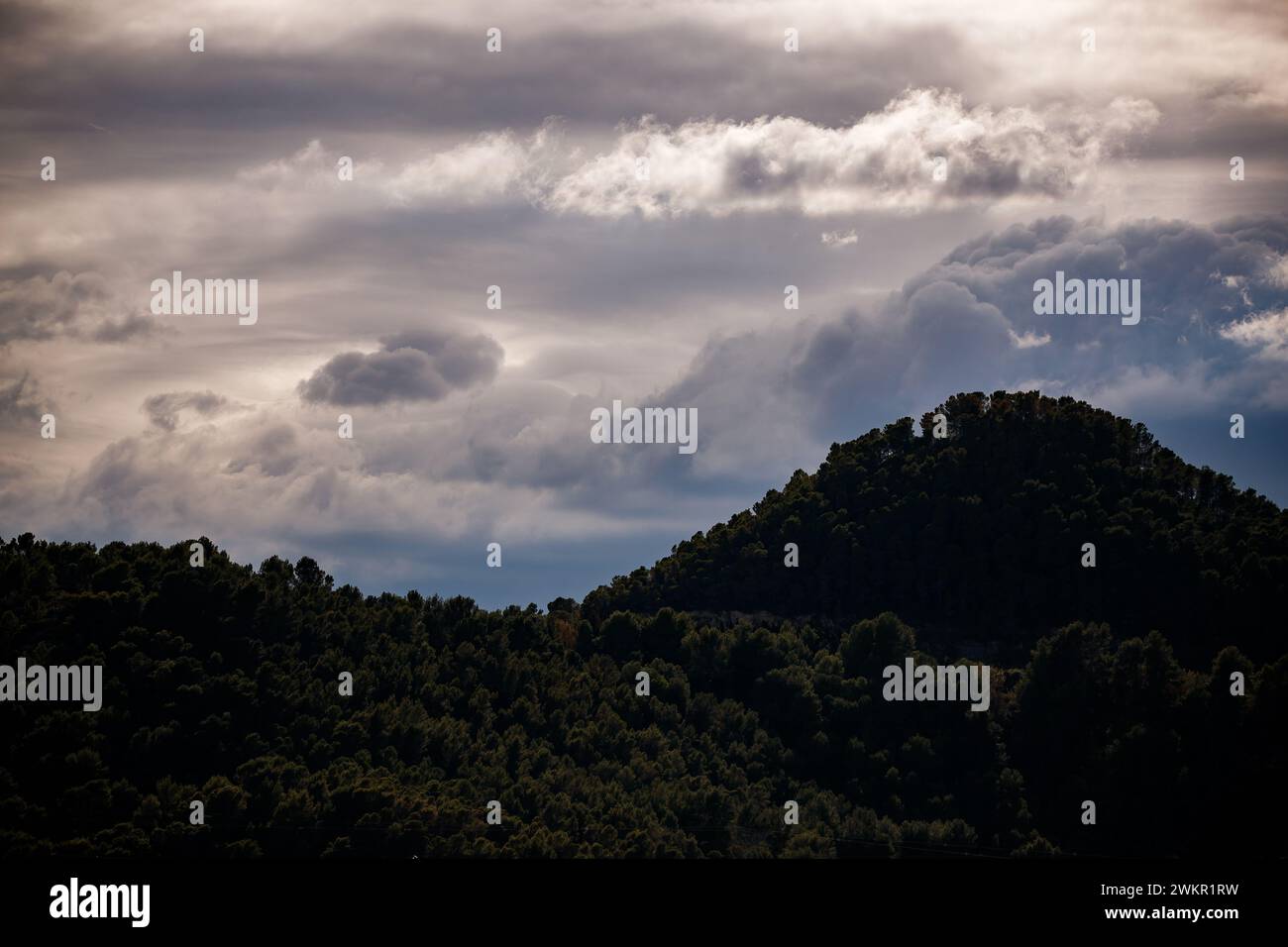 Iridescent clouds over the mountains of Xeraco Stock Photo